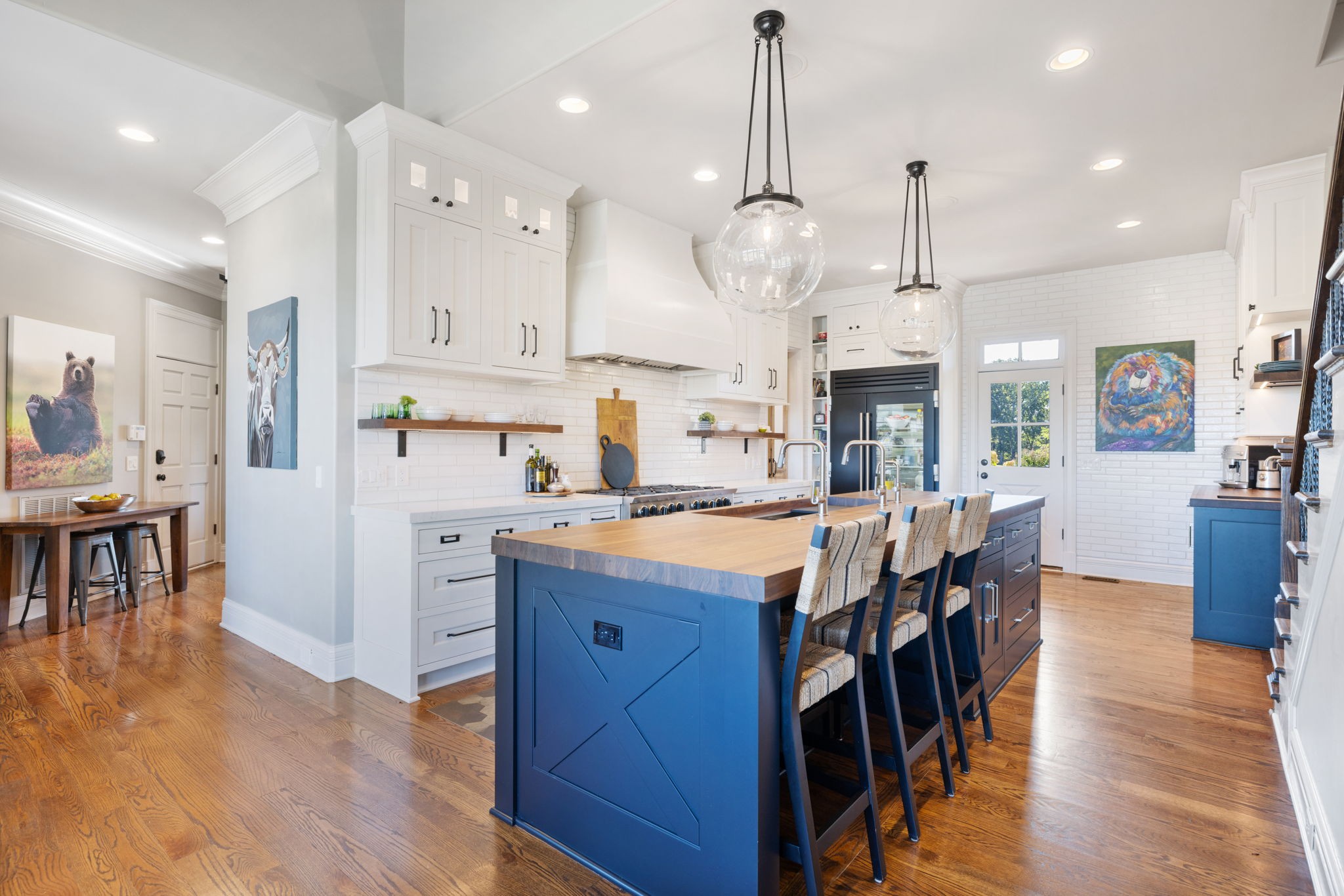 4219 Two Rivers Lane Franklin, TN 37069 - Photo 16 of 69 a kitchen with stainless steel appliances kitchen island granite countertop a table chairs sink and cabinets