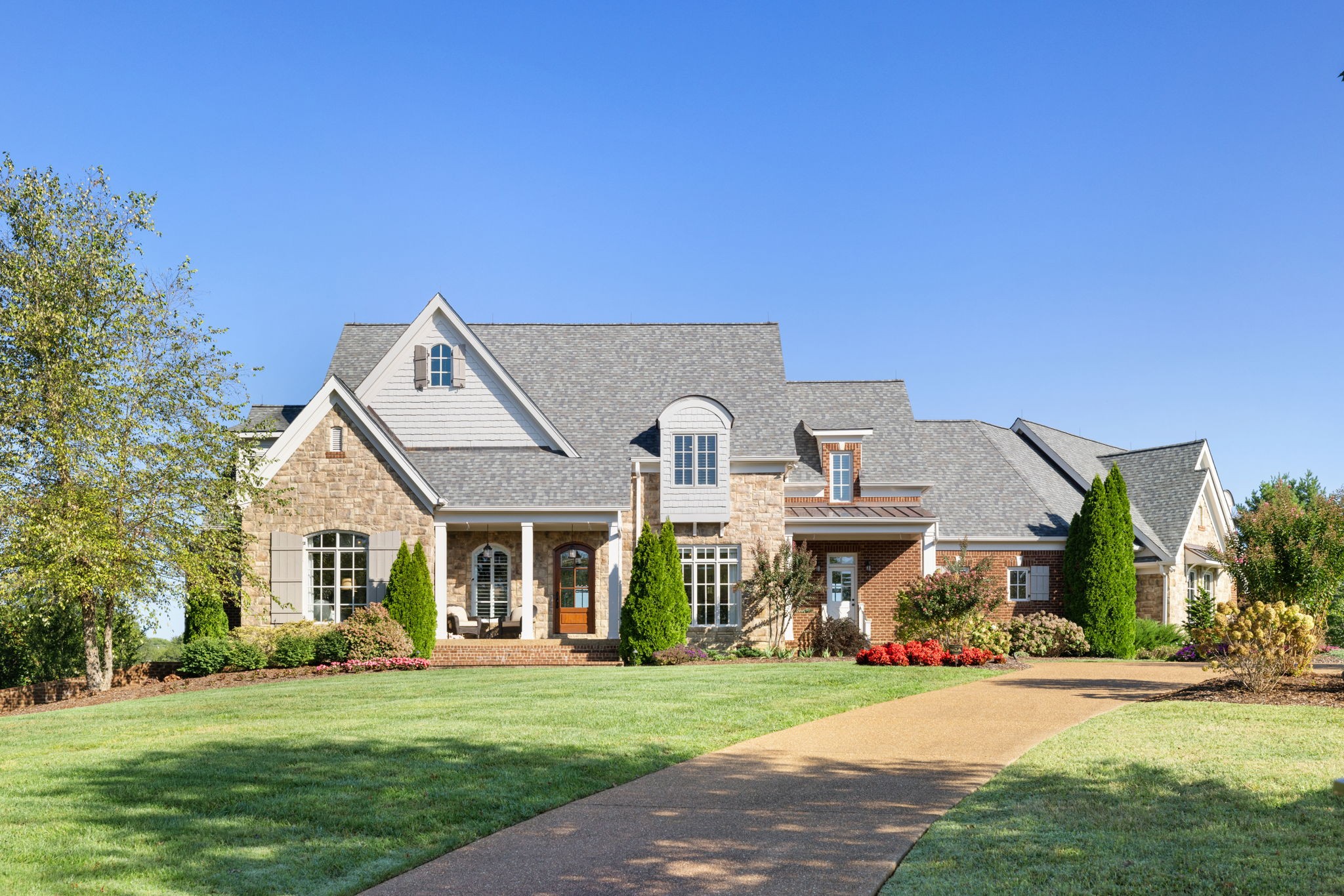 4219 Two Rivers Lane Franklin, TN 37069 - Photo 2 of 69 a front view of a house with a garden and porch