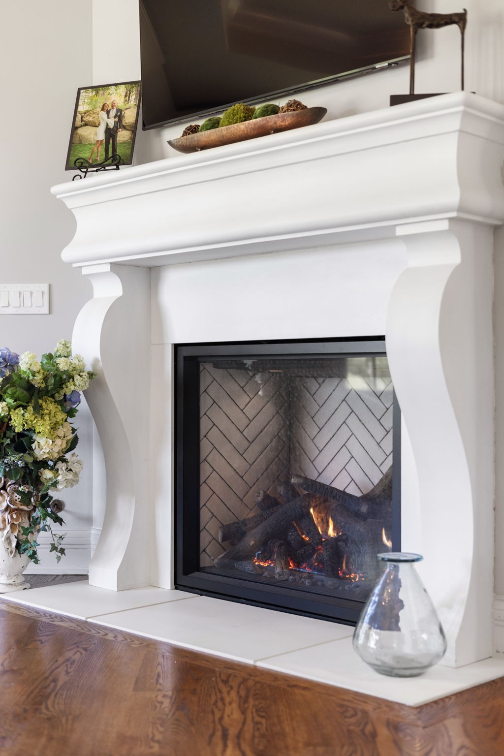 4219 Two Rivers Lane Franklin, TN 37069 - Photo 32 of 69 a fireplace with a vase and flowers on it