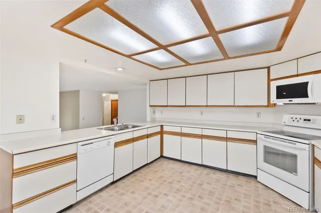 a kitchen with a sink and white cabinets