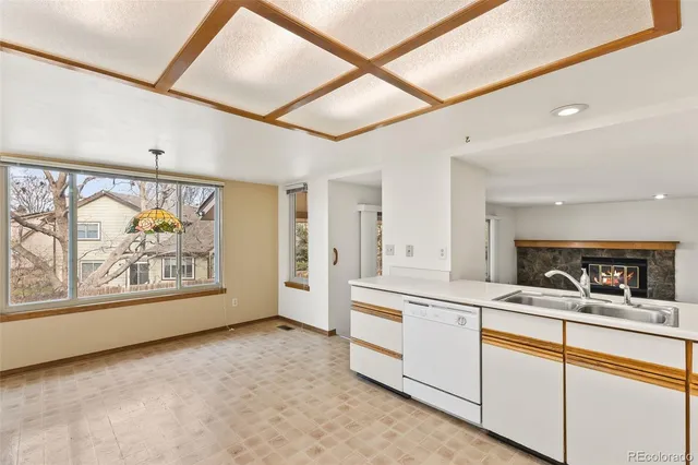 a view of a big room with wooden floor and windows