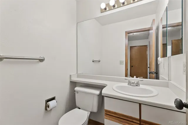 a bathroom with a sink toilet and mirror