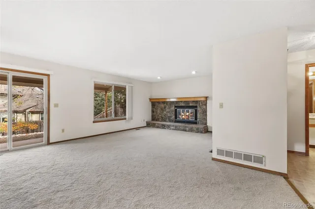 an empty room with furniture and a fireplace