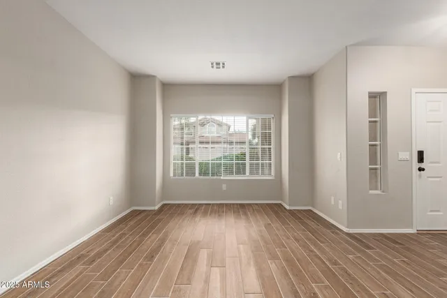 a view of wooden floor and windows in a room