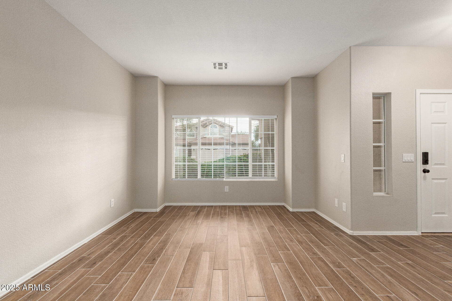 4522 East Rowel Road Phoenix, AZ 85050 - Photo 11 of 49 a view of wooden floor and windows in a room
