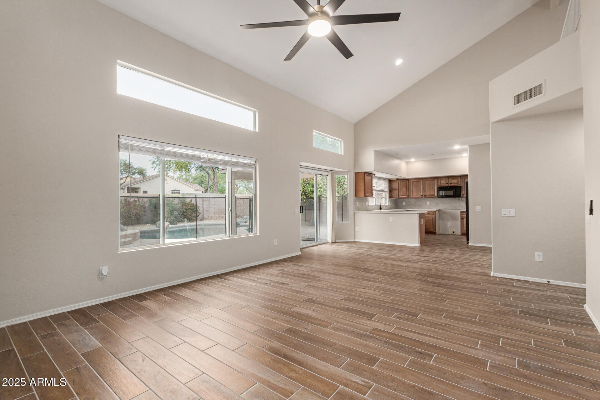 4522 East Rowel Road Phoenix, AZ 85050 - Photo 13 of 49 a view of an empty room with a window and wooden floor