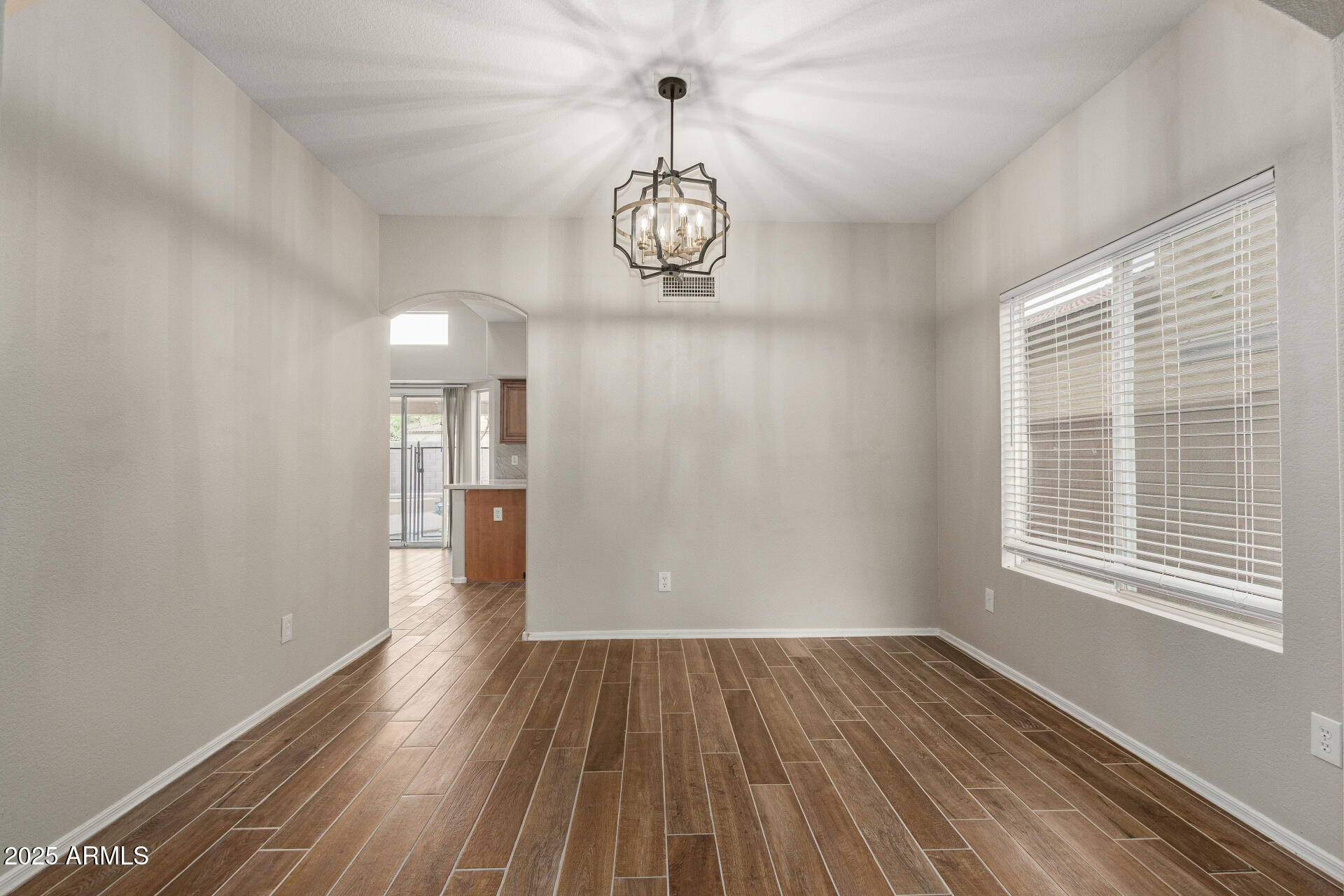 4522 East Rowel Road Phoenix, AZ 85050 - Photo 16 of 49 a view of a room with wooden floor windows and white walls