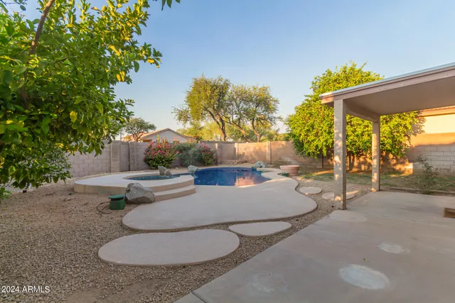 a backyard of a house with table and chairs