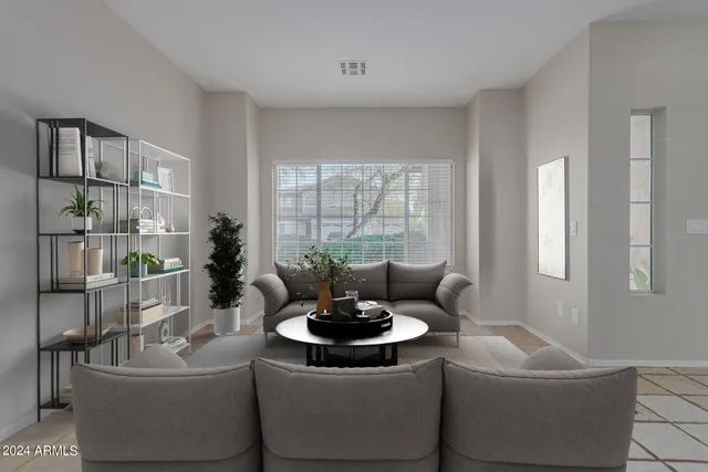 a living room with furniture and a potted plant