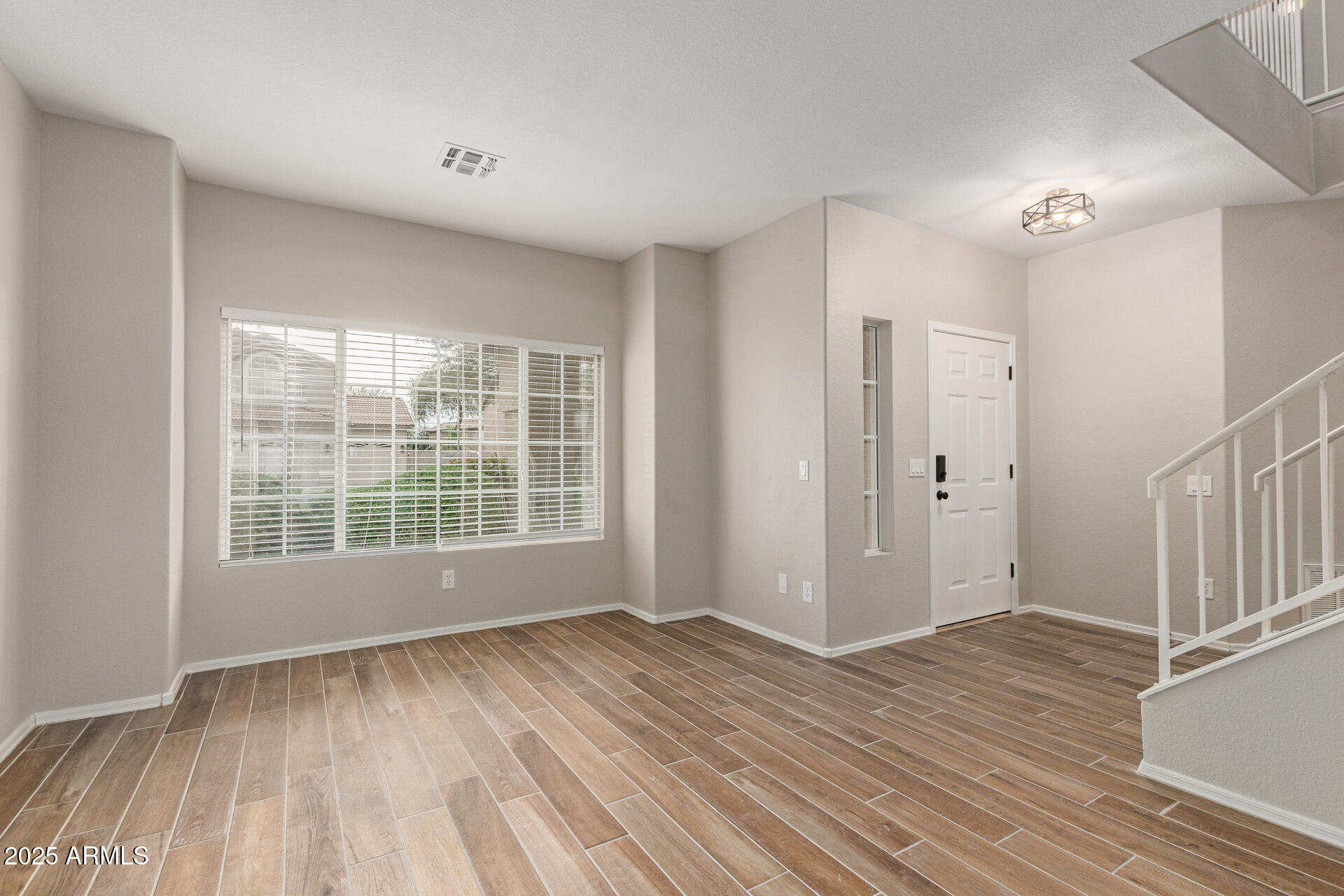 4522 East Rowel Road Phoenix, AZ 85050 - Photo 8 of 49 a view of empty room with wooden floor and fan