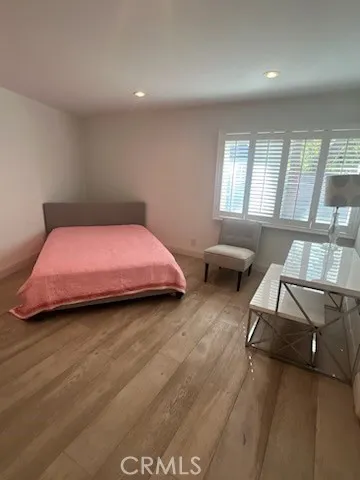 a workspace with wooden floor and white walls
