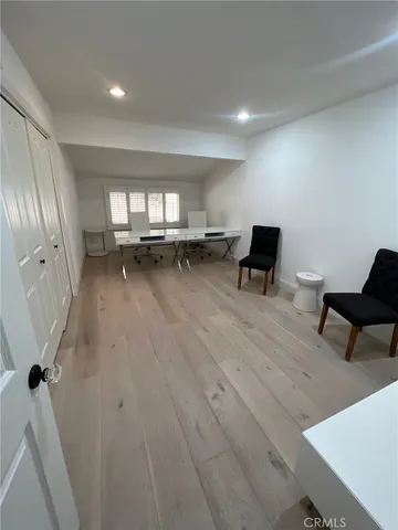a spacious bathroom with a granite countertop sink a mirror and a bathtub