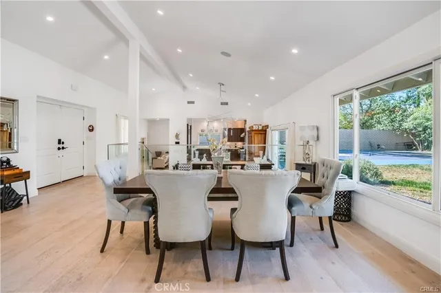 a dining room with furniture and a floor to ceiling window