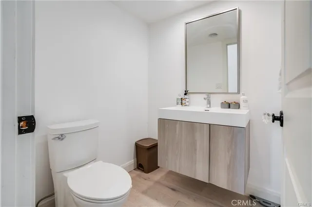 a bathroom with a sink vanity mirror and toilet