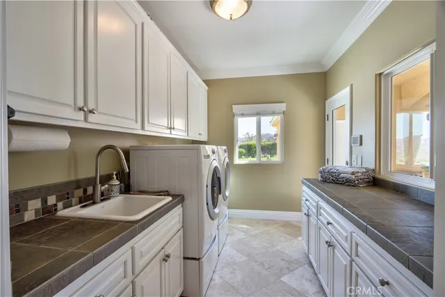 a bedroom with a bed and large windows