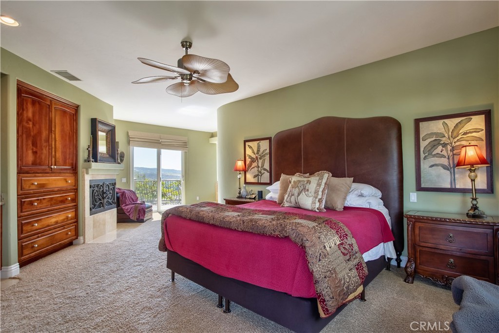 35445 Linda Rosea Road Temecula, CA 92592 - Photo 13 of 21 a spacious bedroom with a bed a dresser and a chandelier