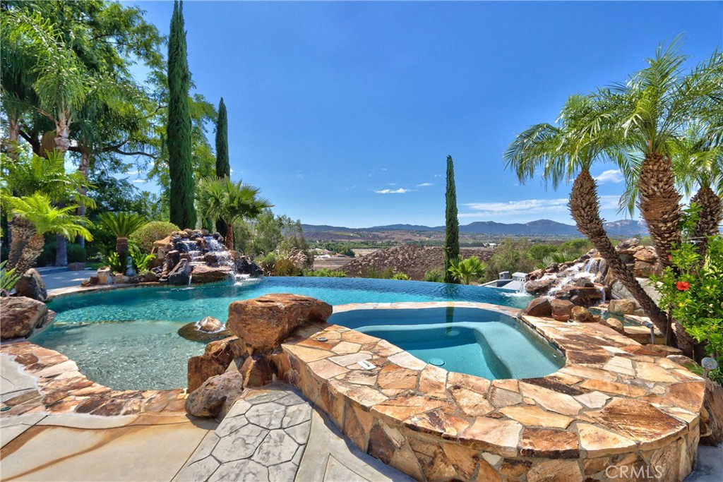 35445 Linda Rosea Road Temecula, CA 92592 - Photo 4 of 21 a view of a swimming pool and lounge chairs in back yard of the house