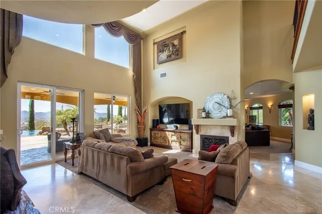 a living room with fireplace furniture and a fireplace