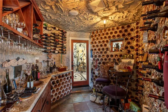 a living room with furniture kitchen view and a large window