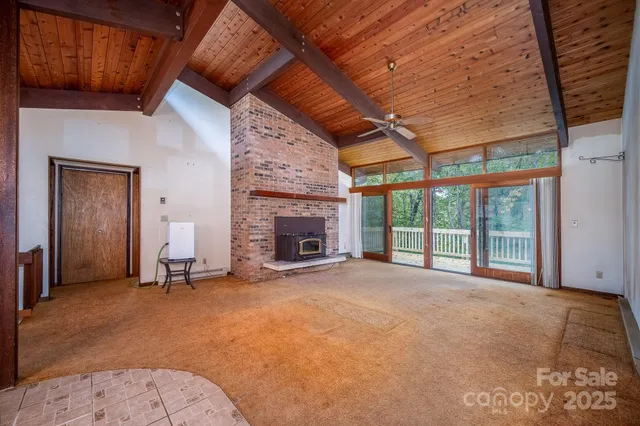 a view of an empty room with a fireplace