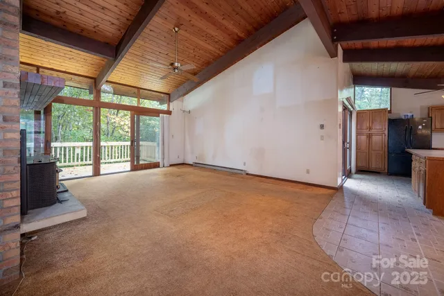 a view of an empty room with a fireplace