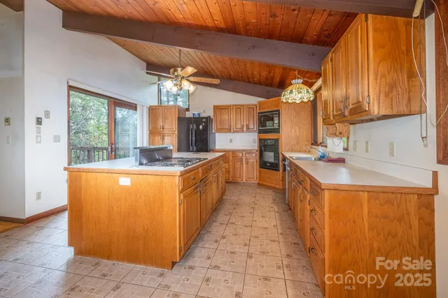 a open kitchen with stainless steel appliances granite countertop a sink and a refrigerator