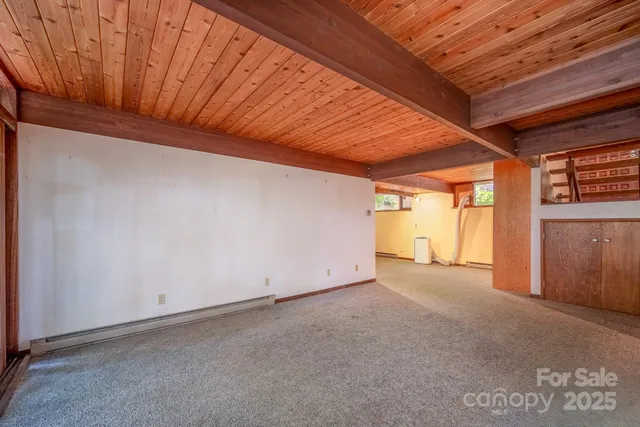 a view of empty room with a fireplace