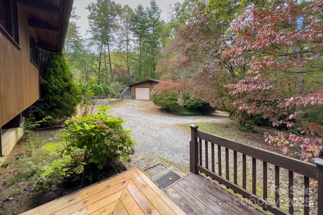 a view of backyard with a deck and wooden floor