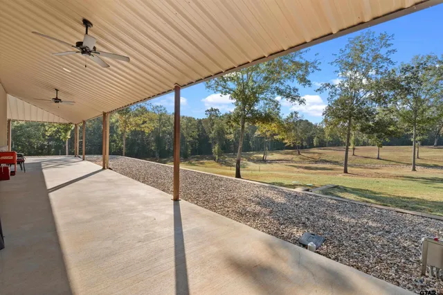 a view of a patio with table and chairs under an umbrella