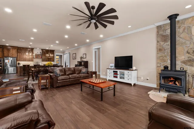 a large kitchen with stainless steel appliances granite countertop a sink and cabinets