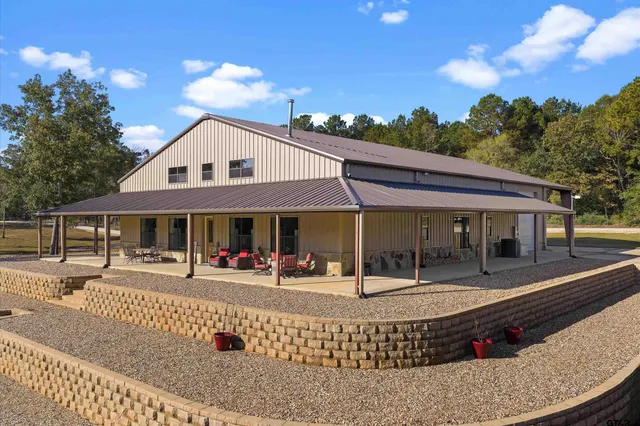 a view of a house with backyard and sitting area