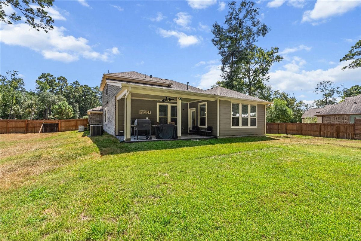 28619 Riverside Crest Lane Huffman, TX 77336 - Photo 36 of 48 Step outside to a huge cleared and fenced backyard with room to play, entertain, garden or simply enjoy the space.