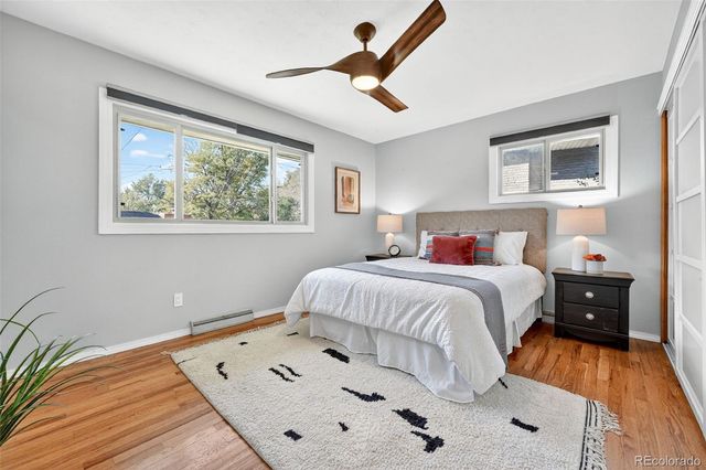 a bedroom with a bed and a painting on the wall