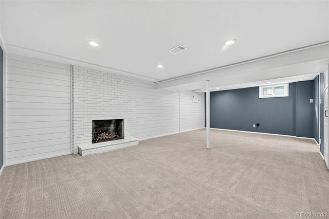 a view of an empty room with a fireplace