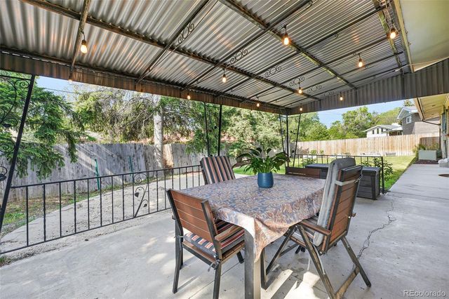 a view of a house with backyard and a patio