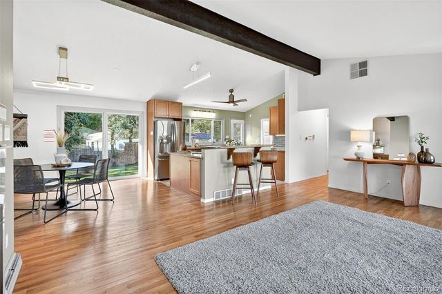 a living room with furniture and a wooden floor