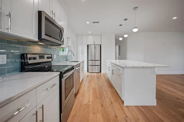 a bathroom with a sink a vanity and a large mirror