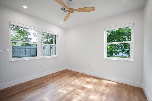 a bathroom with a sink mirror and a shower