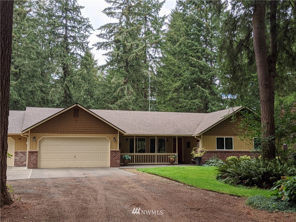 5428 133rd Avenue Southwest Rochester, WA 98579 - Photo 1 of 21 a view of a house with a yard and large trees