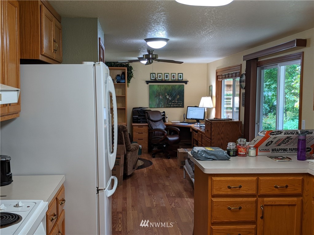 5428 133rd Avenue Southwest Rochester, WA 98579 - Photo 17 of 21 a kitchen with a refrigerator and a stove