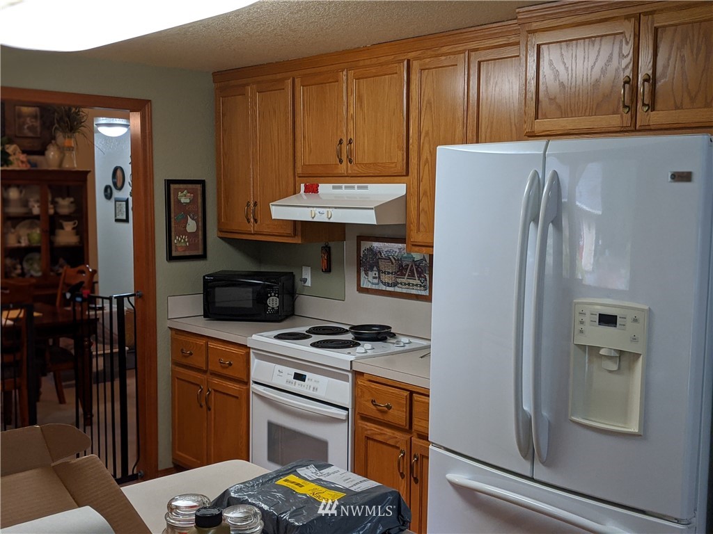 5428 133rd Avenue Southwest Rochester, WA 98579 - Photo 18 of 21 a kitchen with stainless steel appliances granite countertop a refrigerator and a stove top oven