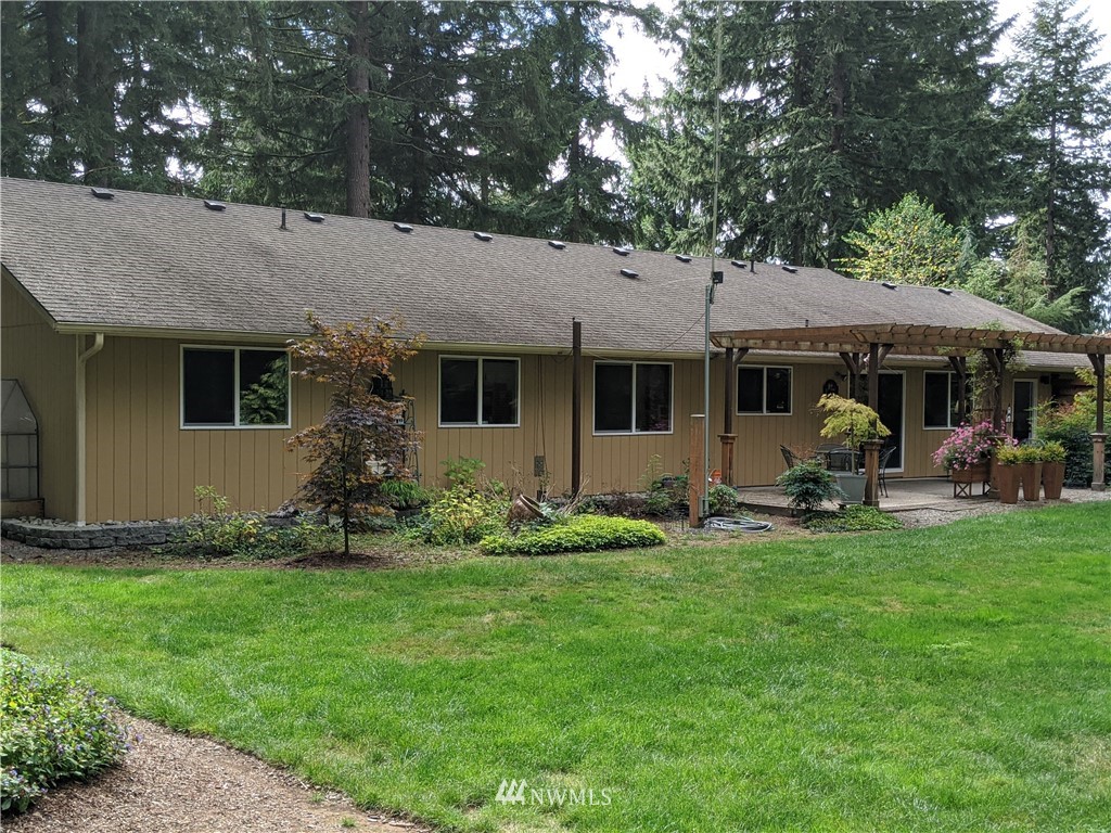 5428 133rd Avenue Southwest Rochester, WA 98579 - Photo 20 of 21 a front view of a house with garden