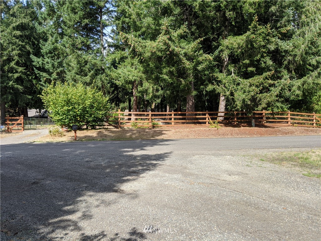 5428 133rd Avenue Southwest Rochester, WA 98579 - Photo 5 of 21 a backyard of a house with trees and houses