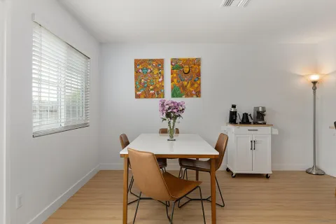 a dining room with furniture and window