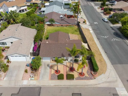 an aerial view of a house with a yard and lake