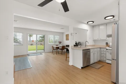 a living room with furniture and a kitchen view