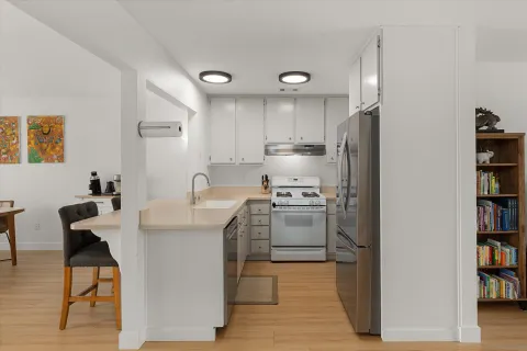 a kitchen that has a lot of cabinets in it and appliances