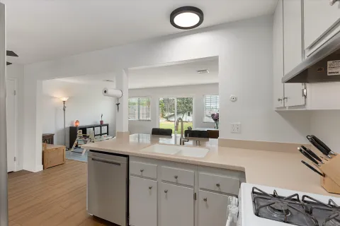 a kitchen with sink and cabinets