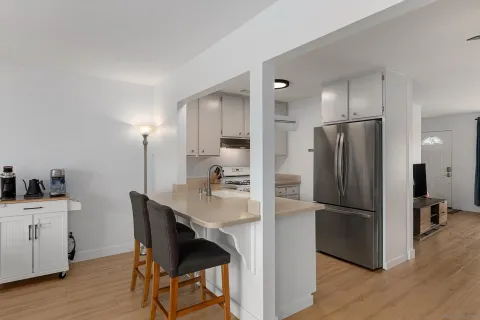 a kitchen with stainless steel appliances a refrigerator a stove a sink and a refrigerator