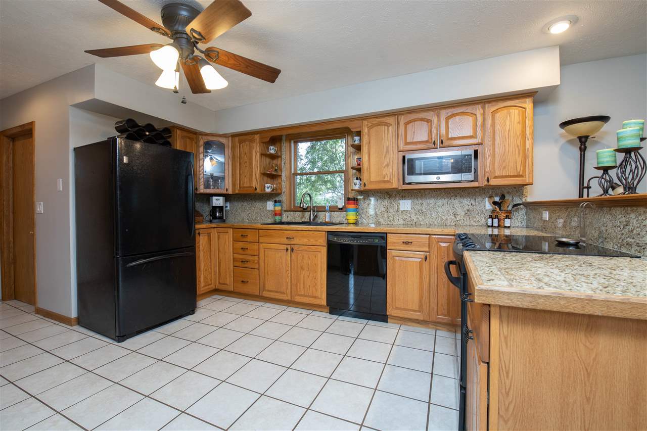 8488 Grange Hall Road Garden Prairie, IL 61038 - Photo 11 of 35 a kitchen with a stove a sink and a refrigerator